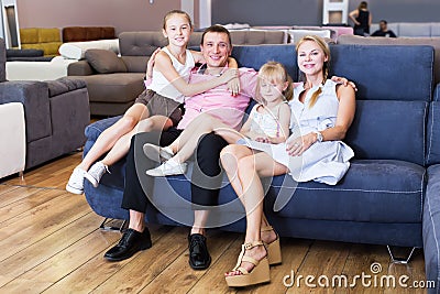 Family posing near new sofa Stock Photo