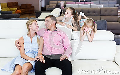 Family posing near new sofa Stock Photo