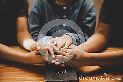 Family pray together praying with parent at home Stock Photo