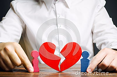 Family psychologist collects the red heart near a couple lovers. Renewal of the relationship. Family psychotherapist services. Stock Photo