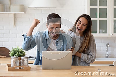 Family reading e-mail from bank on laptop celebrate loan approval Stock Photo
