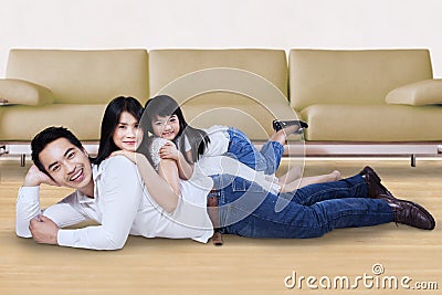 Family relaxing on the floor at home Stock Photo