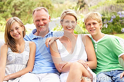 Family Relaxing In Garden Stock Photo