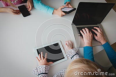 Family on remote work and learning, father and kids using gadgets Stock Photo