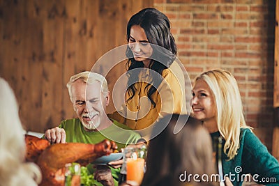 Family reunion young generation taking care of old generation celebrate thanksgiving eat dinner table house living room Stock Photo