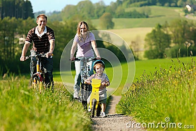 Family riding bicycles in summer Stock Photo