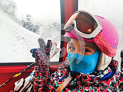 Family riding cabin cable car on winter vacation skiing Stock Photo