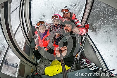 Family riding cabin cable car on winter vacation skiing Stock Photo