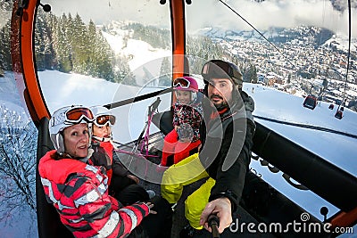 Family riding cabin cable car on winter vacation skiing Stock Photo