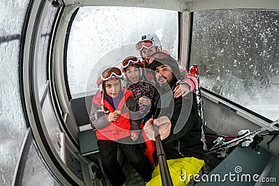 Family riding cabin cable car on winter vacation skiing Stock Photo