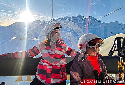 Family riding cabin cable car on winter vacation skiing Stock Photo