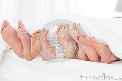 Family's feet in the bed Stock Photo