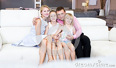Family is satisfied by new bought sofa Stock Photo