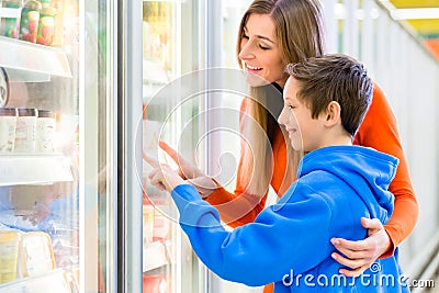 Family selecting cooled products in hypermarket Stock Photo