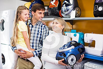 Family selecting vacuum cleaner Stock Photo