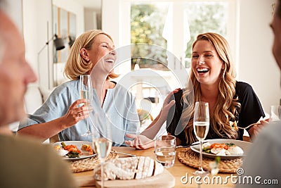 Family With Senior Parents And Adult Offspring Eating Brunch Around Table At Home Together Stock Photo