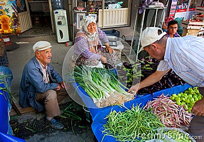 Family of seniors sells herbs, onions and peppers from a farm on village market in Turkey Editorial Stock Photo