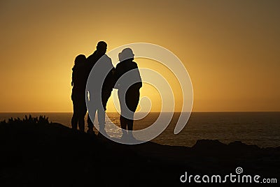 Family silhouette overlooking the ocean Stock Photo