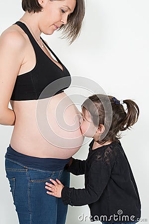 family single mother waiting newborn while daughter kiss pregnant belly Stock Photo