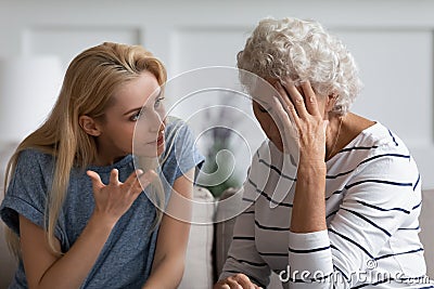 Grownup daughter proves her right aggressively argue with elderly mother Stock Photo