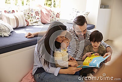 Family Sitting On Floor Reading Story At Home Together Editorial Stock Photo