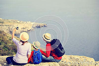 Family with small kid travel in scenic summer Stock Photo