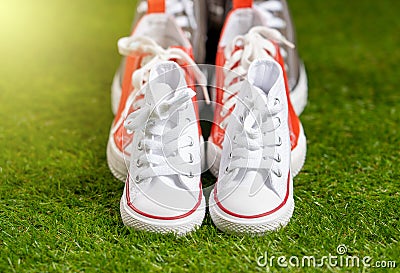 Family sneakers canvas mother father and child shoes on green grass in happy family lifestyle Stock Photo