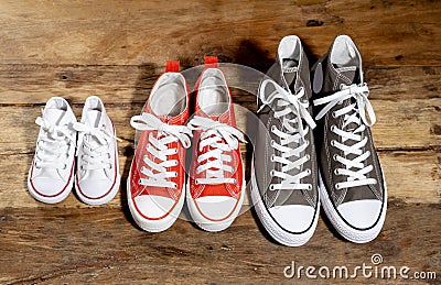 Family Sneakers canvas shoes parents and child on wood floor at home in happy lifestyle Stock Photo