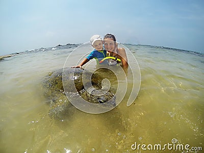 Family snorkeling with turtle Stock Photo