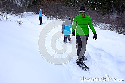 Family Snowshoeing in the Winter Snow Stock Photo