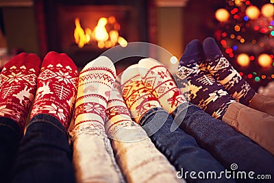 Family in socks near fireplace in winter Stock Photo