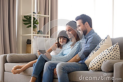 Family spend free time watching cartoons on mobile phone Stock Photo