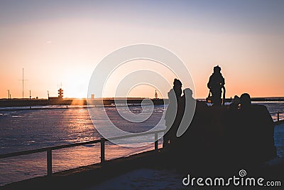 Family spending time during the sunset by the sea Editorial Stock Photo