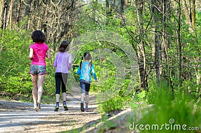 Family sport, happy active mother and kids jogging outdoors Stock Photo