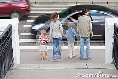 Family standing near pedestrian crossing Stock Photo