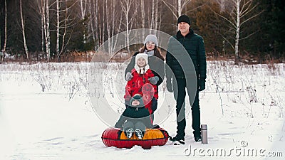 Family standing outdoors at winter and looking in the camera Stock Photo