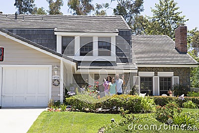 Family Standing Outside Their House Stock Photo