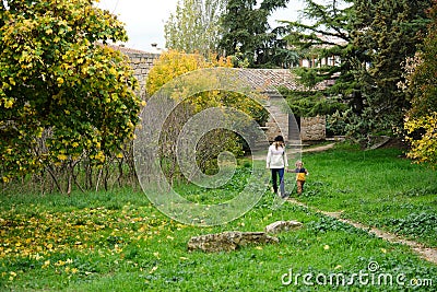 Family strolling in a park in the fall Stock Photo