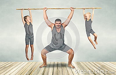 Family of strongman. Father and two sons in vintage costumes drag the rope. Family look. Stock Photo