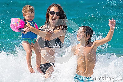 Family summer sea fun water splash Stock Photo