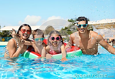 Family in swimming pool. Summer vacation Stock Photo