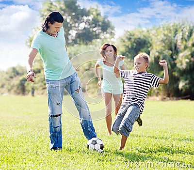 Family with teenager child playing with soccer ball Stock Photo