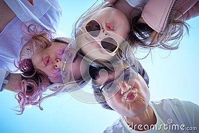 family of three looking down at the camera. Stock Photo