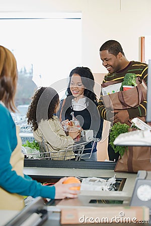 A family at a till Stock Photo