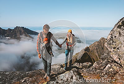 Family travel vacations man and woman hiking with baby carrier outdoor in mountains healthy lifestyle Stock Photo