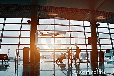 Family traveling with children, silhouette in airport Stock Photo