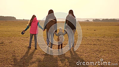 Family travels with the dog across the plains and mountains. mother, daughters and home pets tourists. teamwork of a Stock Photo