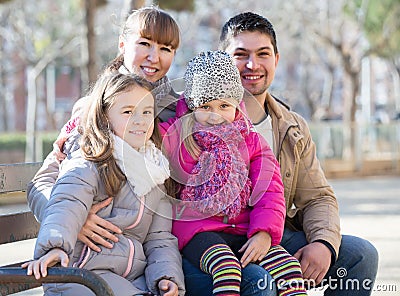 Family with two girls outdoors in sunny fall day Stock Photo
