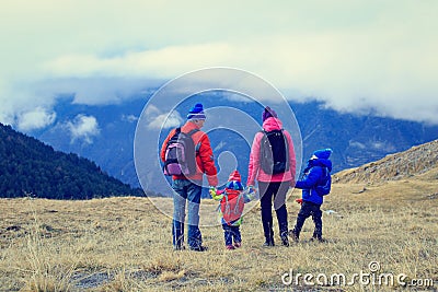 Family with two kids hiking in winter mountains Stock Photo