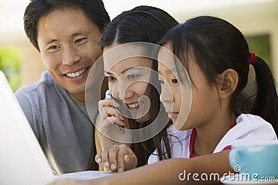 Family Using Laptop in backyard Stock Photo